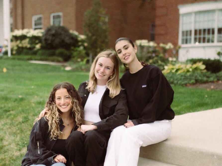 3 Girls on steps smiling near Ohio State's Campus in Columbus OH