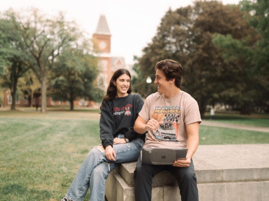 two OSU students looking at a computer