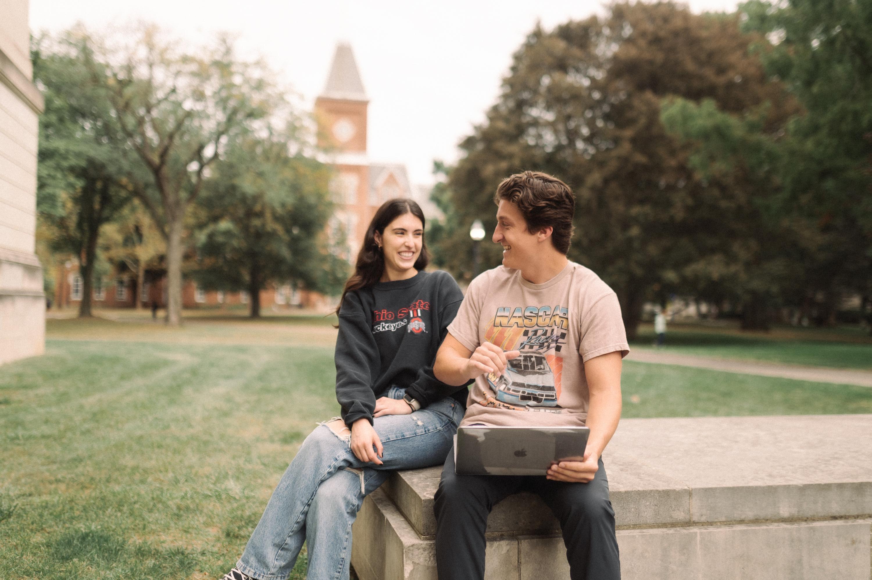 two OSU students looking at a computer