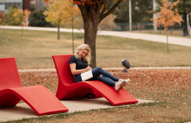 girl writing in her journal on ohio state campus