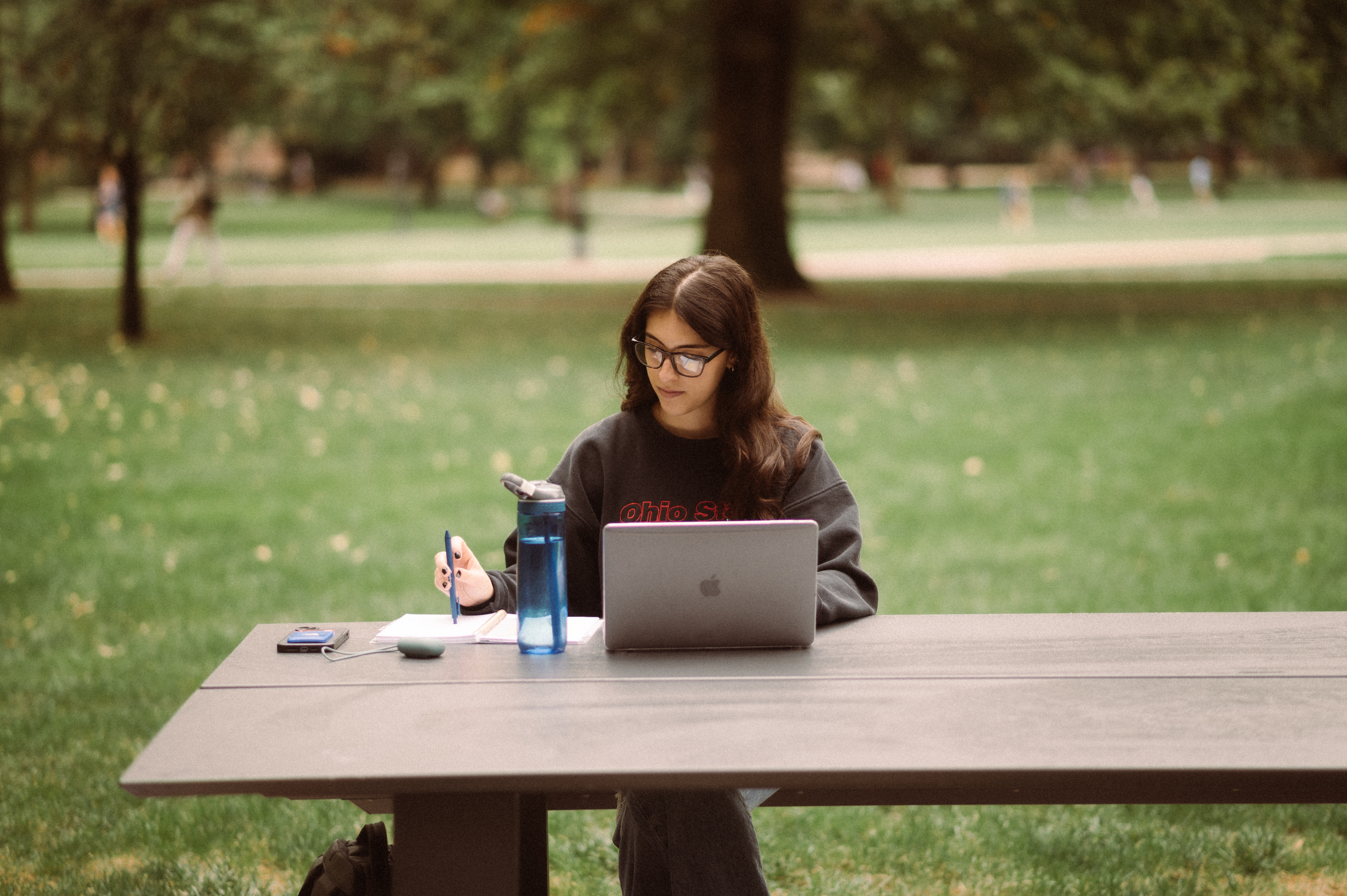 girl working on her computer on OSU campus