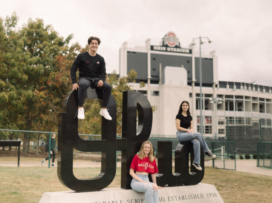 3 students near script ohio on ohio states campus