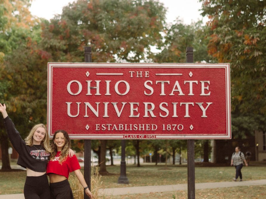 2 girls in front of the Ohio State University Sign