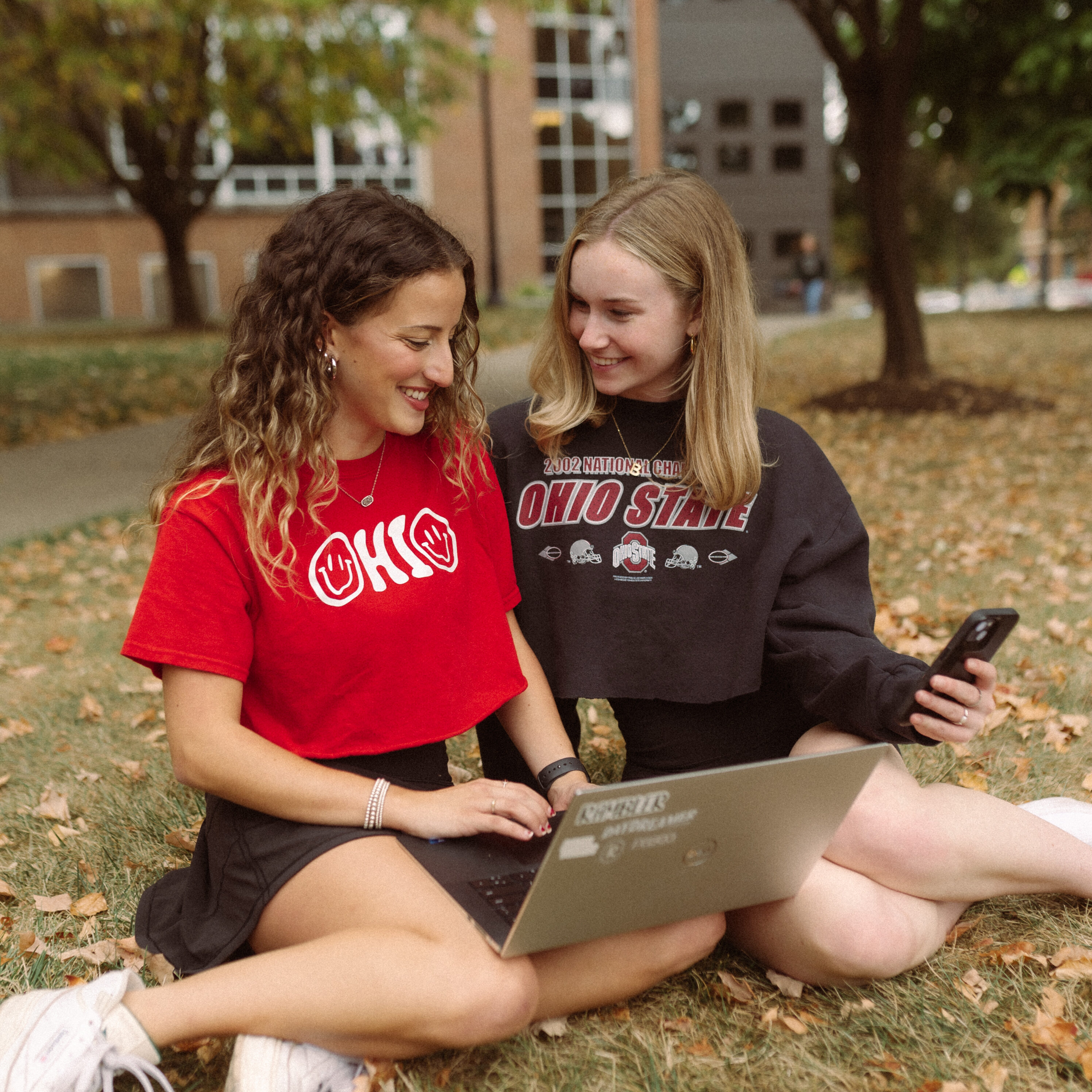 Two girls looking at computer on ohio states campus