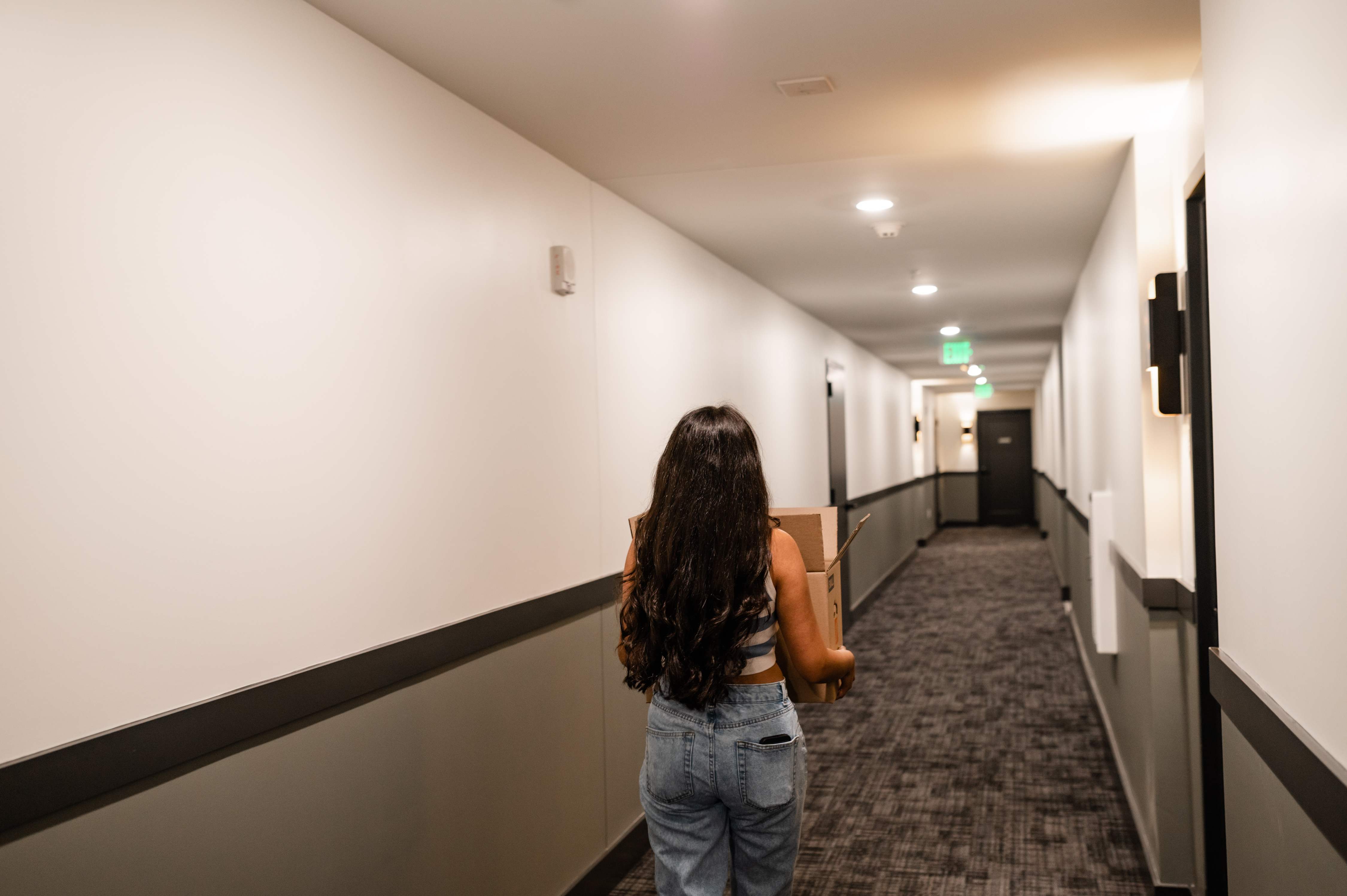 girl moving package in hallway