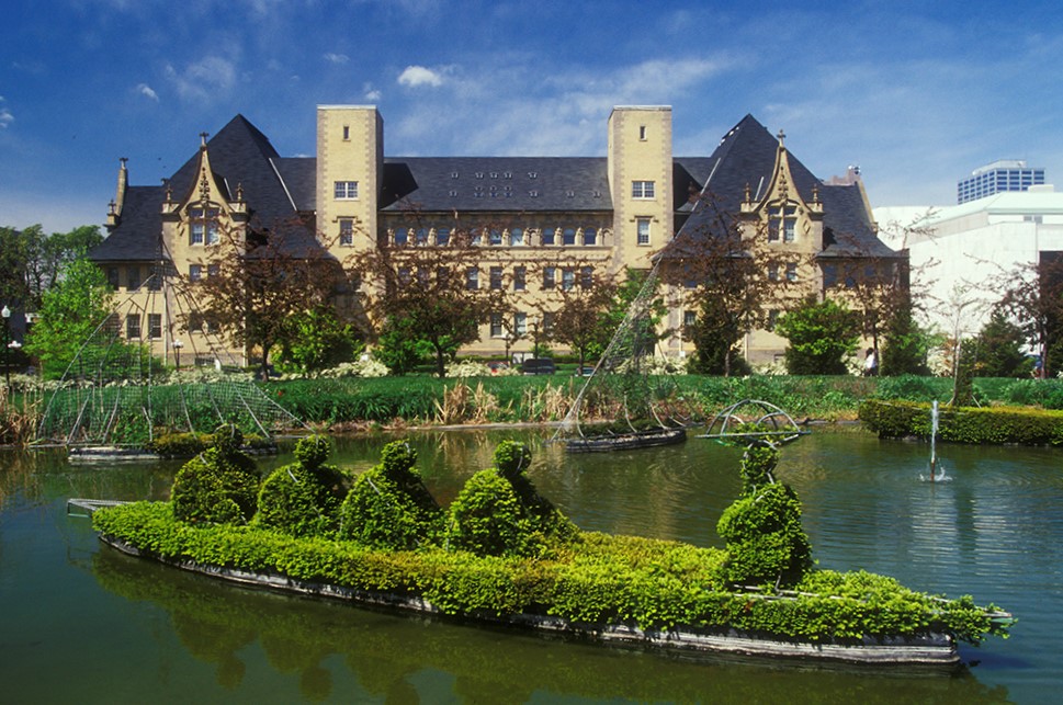 Topiary Park a huge mansion with a pond full of lush greenery and landscape