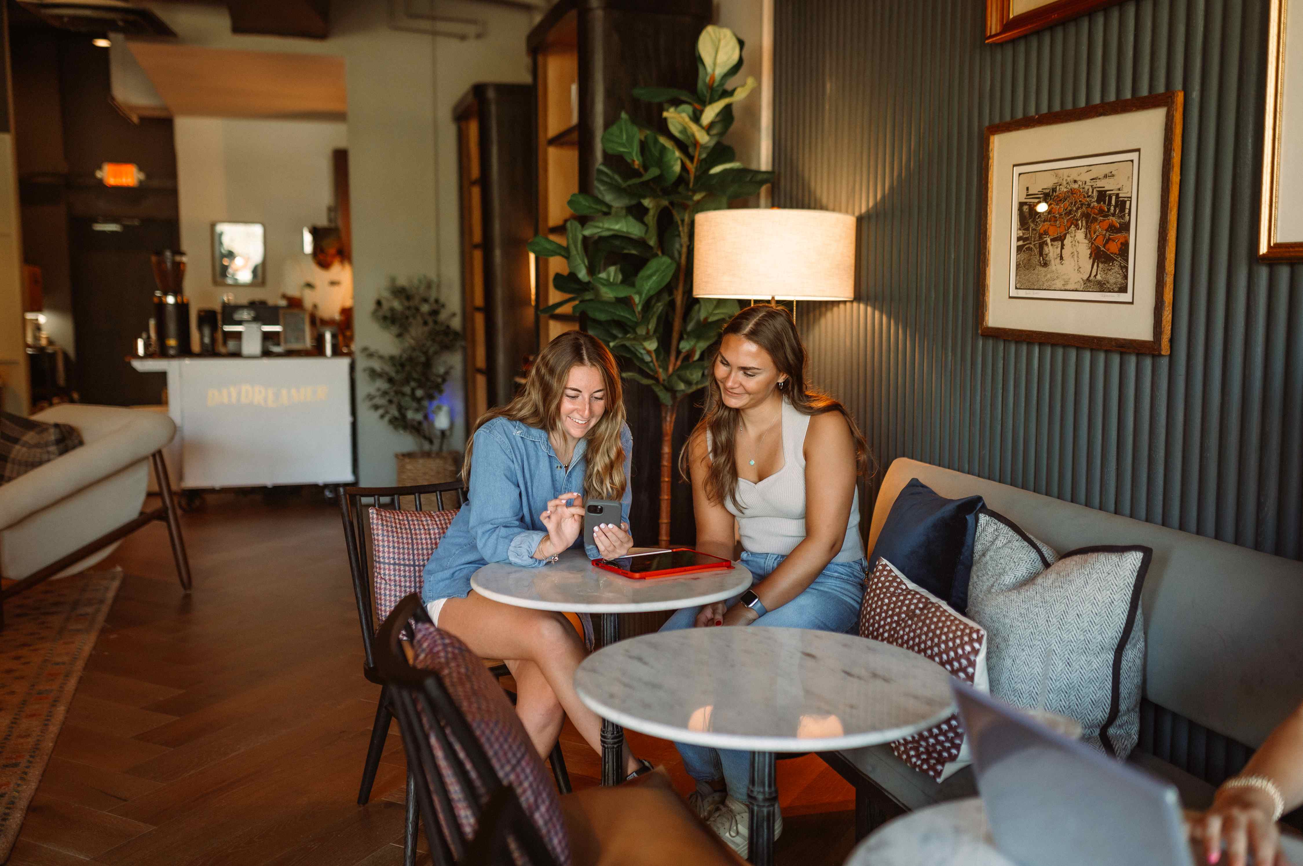 two girls sitting together in a coffee shop