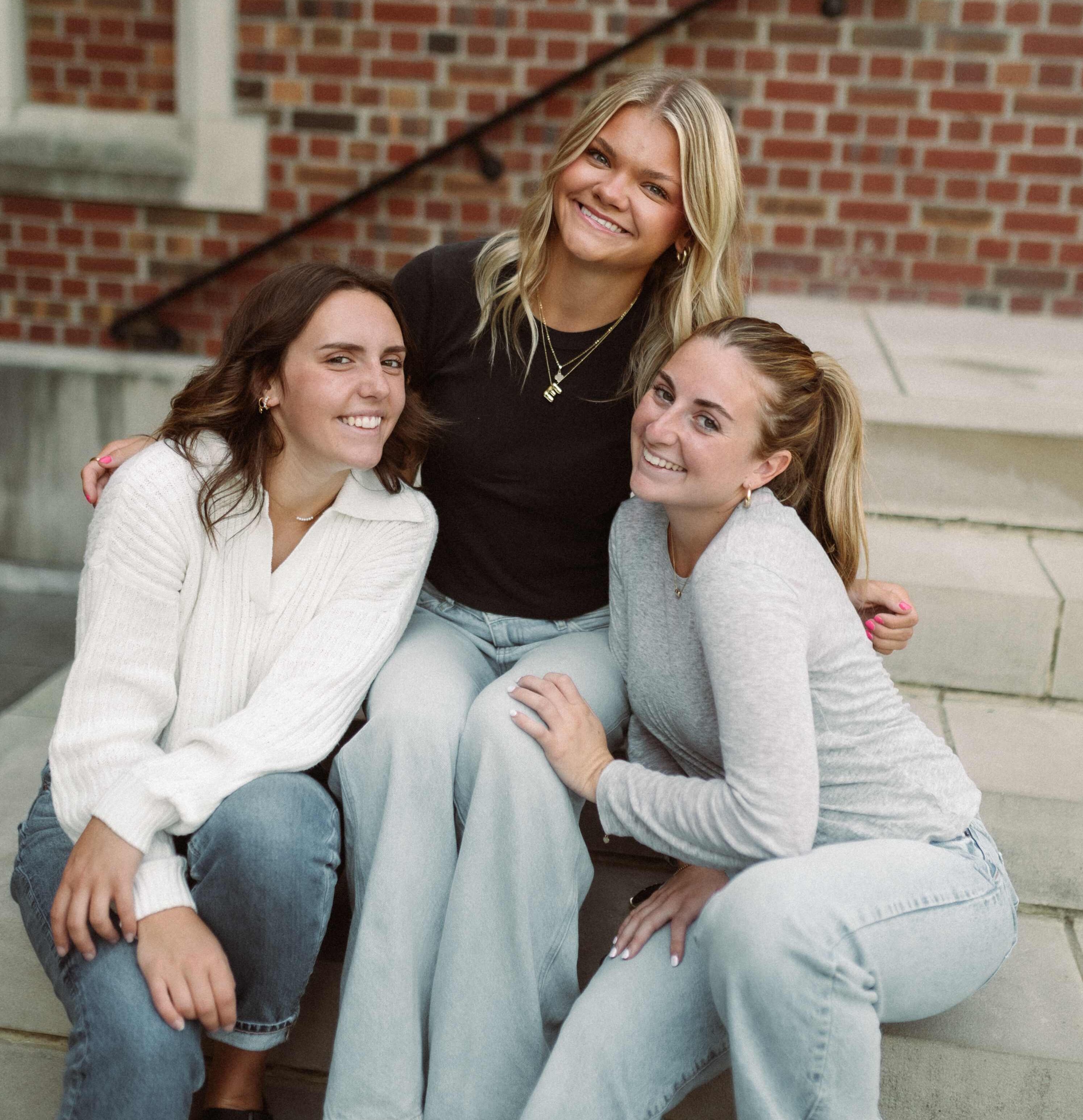 three girls sitting on steps at ohio state's campus