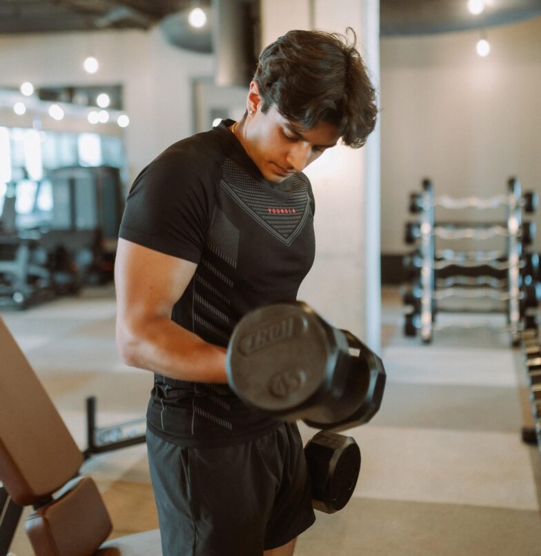 Guy doing a bicep curl in the Rambler fitness center