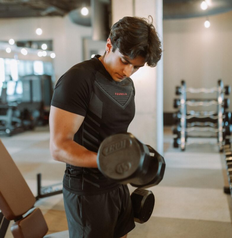 Guy doing a bicep curl in the Rambler fitness center