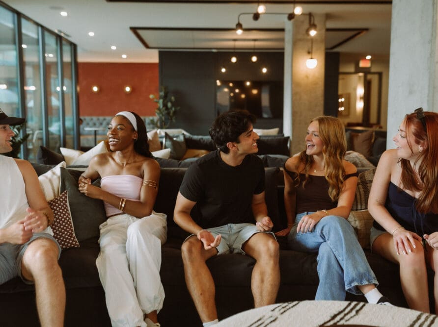 friends talking on couch at rambler col